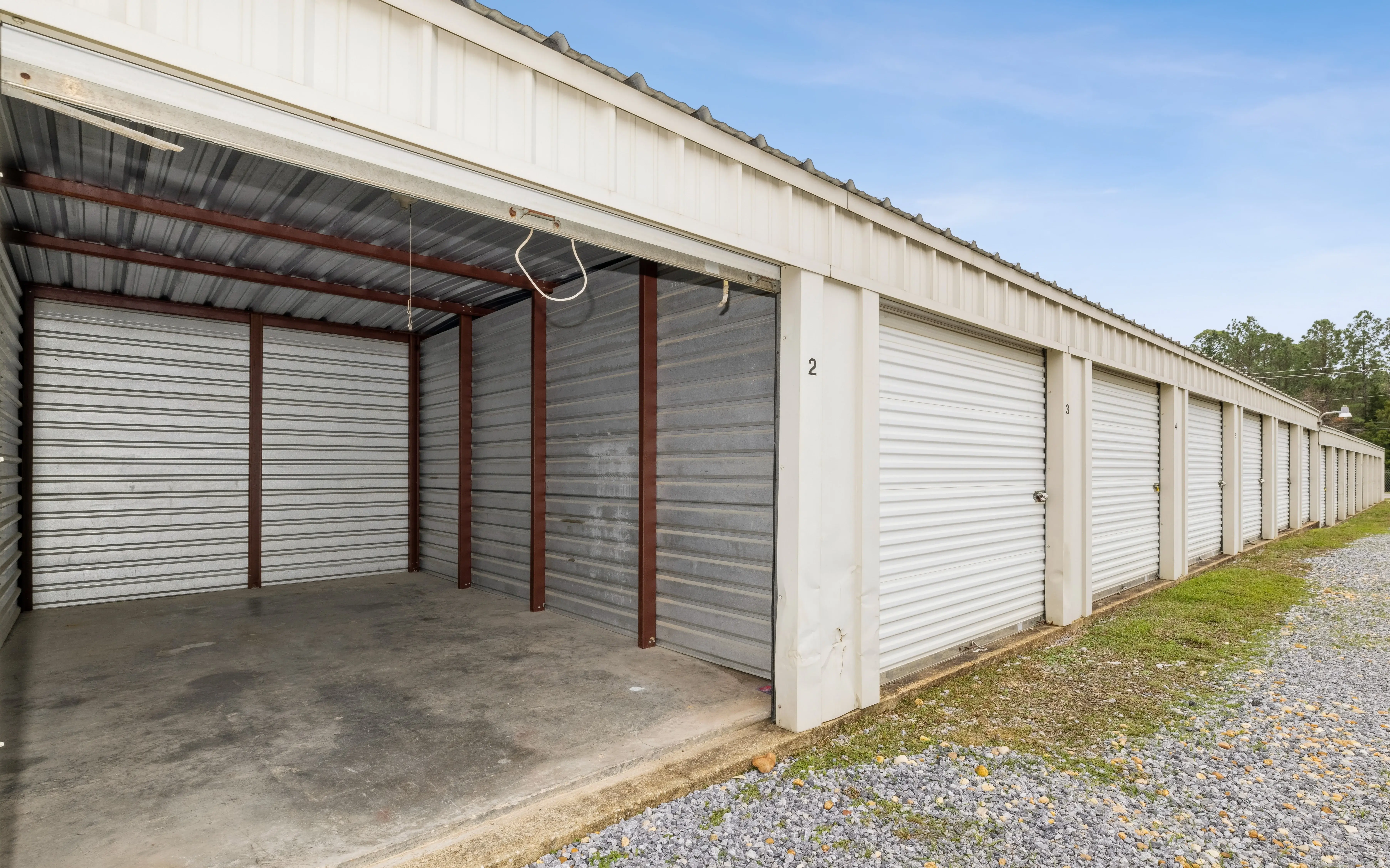 open storage units showing interior framing and concrete floors at our Pensacola FL location