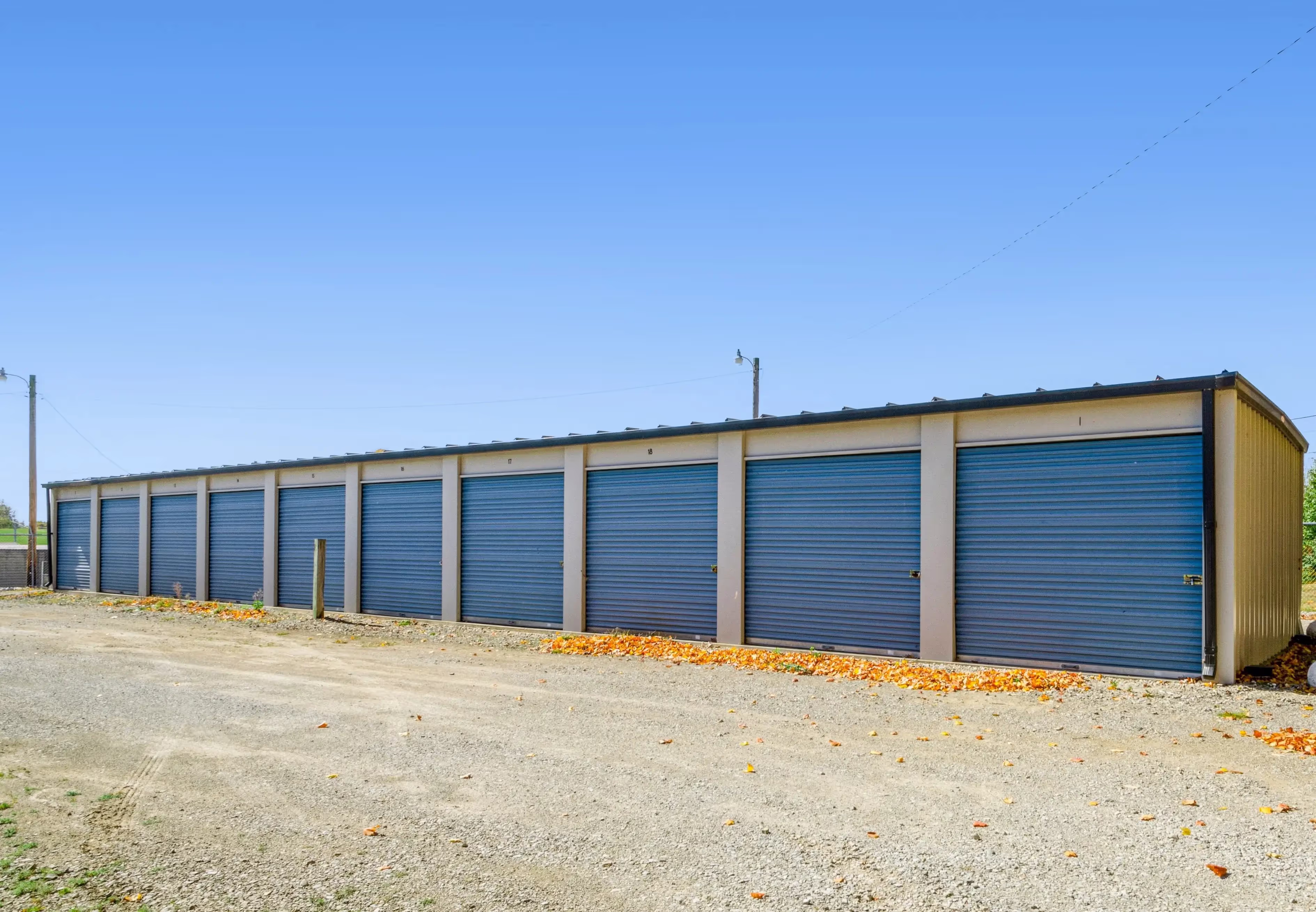 A long row of blue roll up storage units along a wide gravel drive at our Peru IN facility
