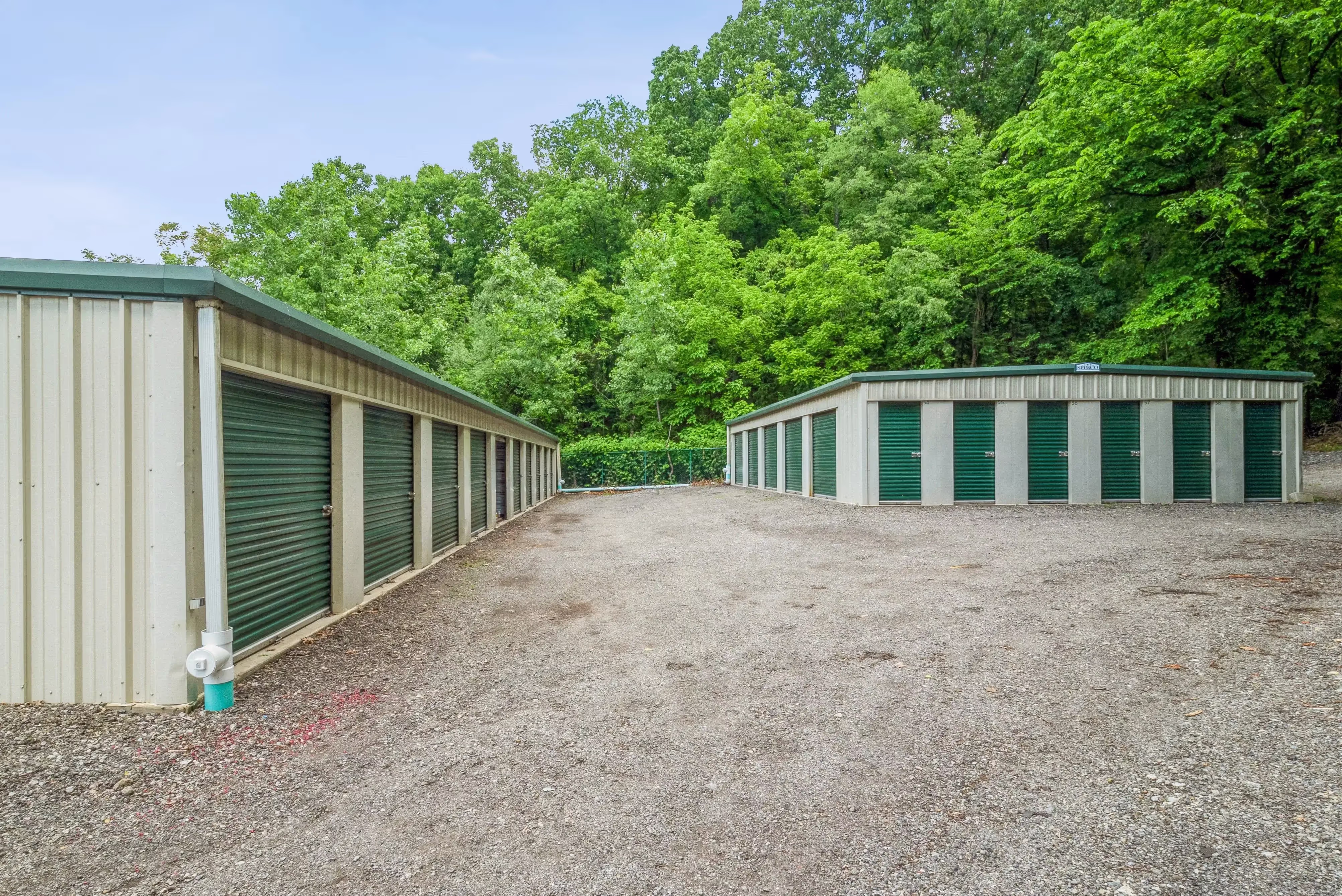 Two self storage buildings in Pittsburgh, PA with green doors storage units