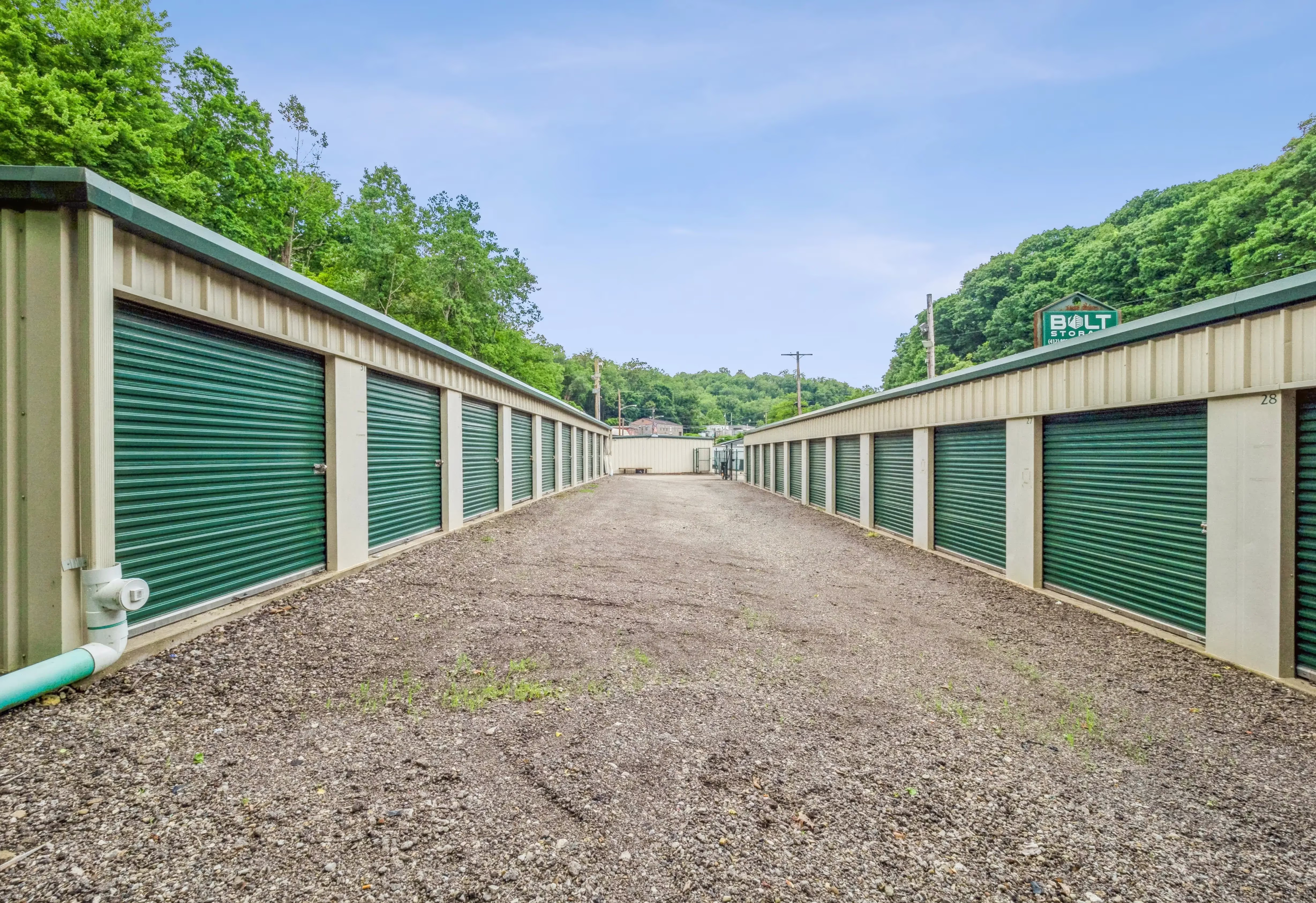Two self storage buildings in Pittsburgh, PA with green doors storage units