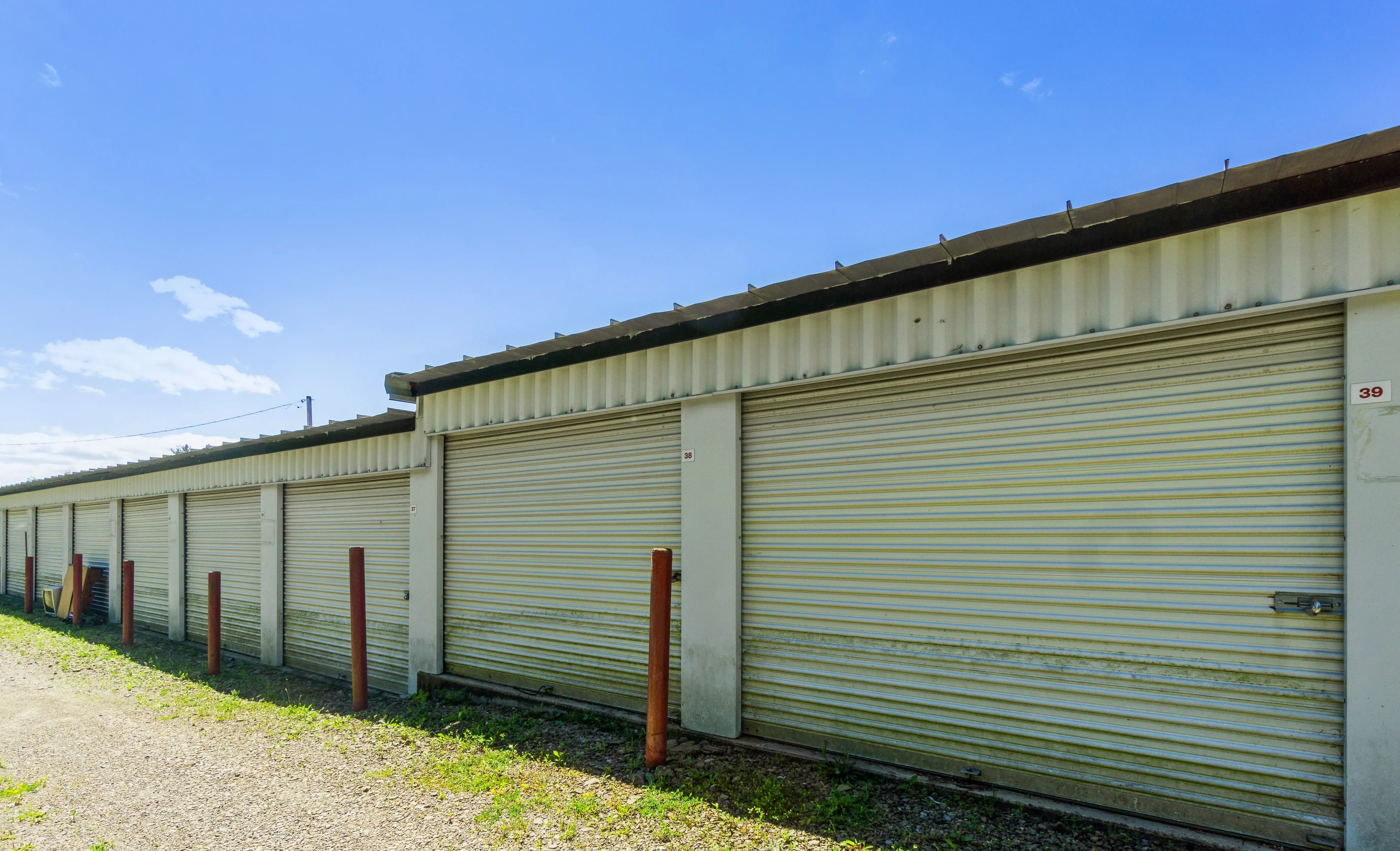 white roll up storage units with red corner posts under a bright blue sky in Union City PA