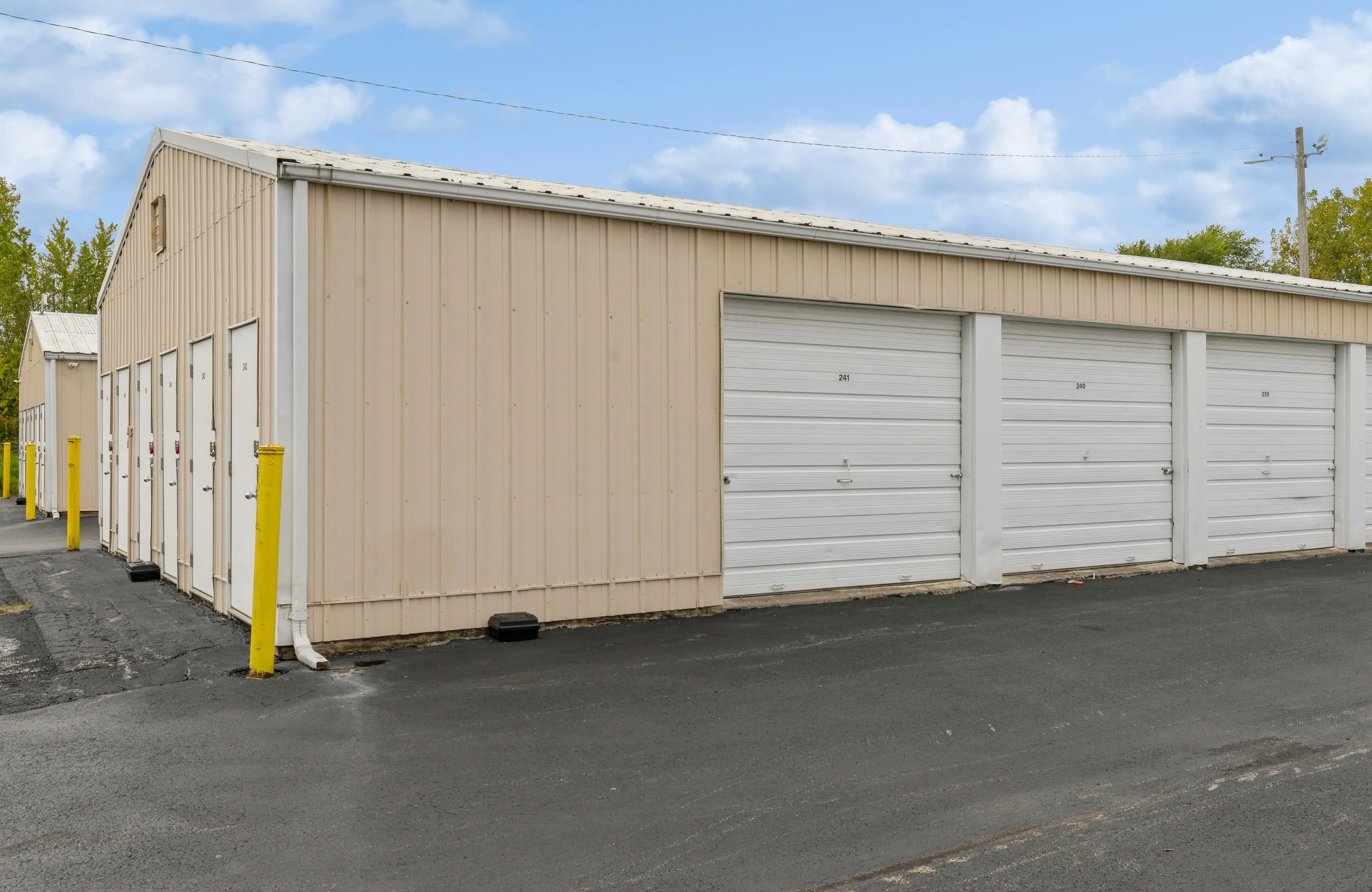 Angled view of drive up storage buildings with white roll up doors in Moline IL