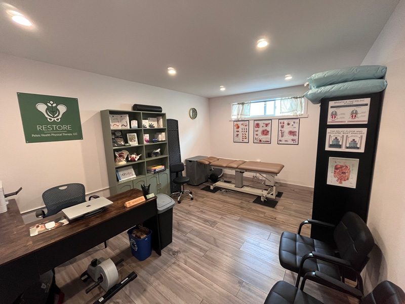 physical therapy office with desk and chair for patients