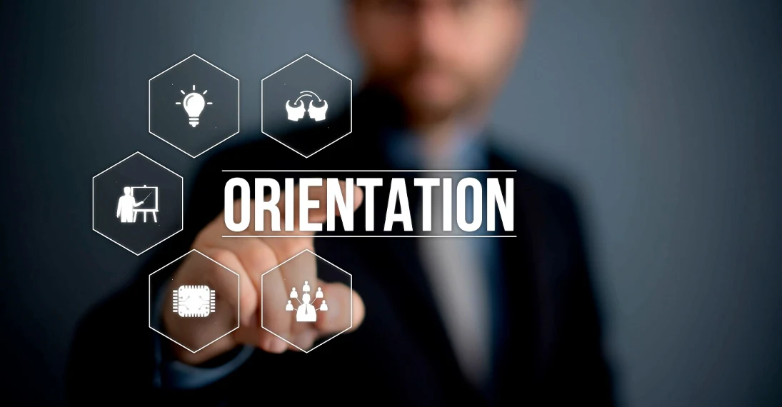 Blurred man in business suit pointing at floating hexagons with icons and the word ORIENTATION in bold white letters.