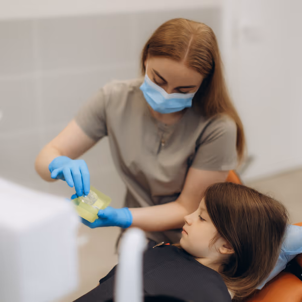 Illustration of professional fluoride application to strengthen teeth and prevent decay