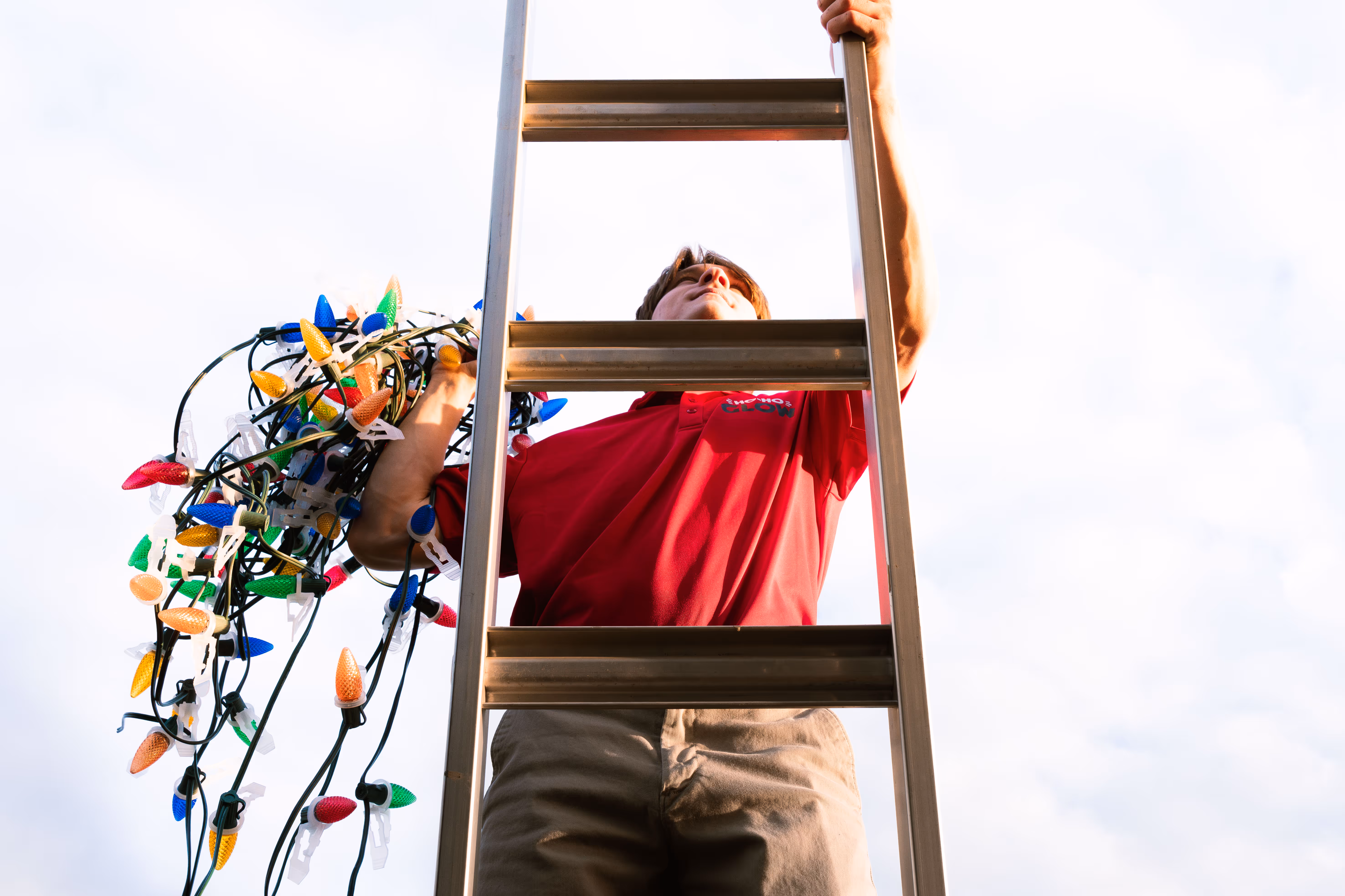 Employee installing professional Christmas lighting.