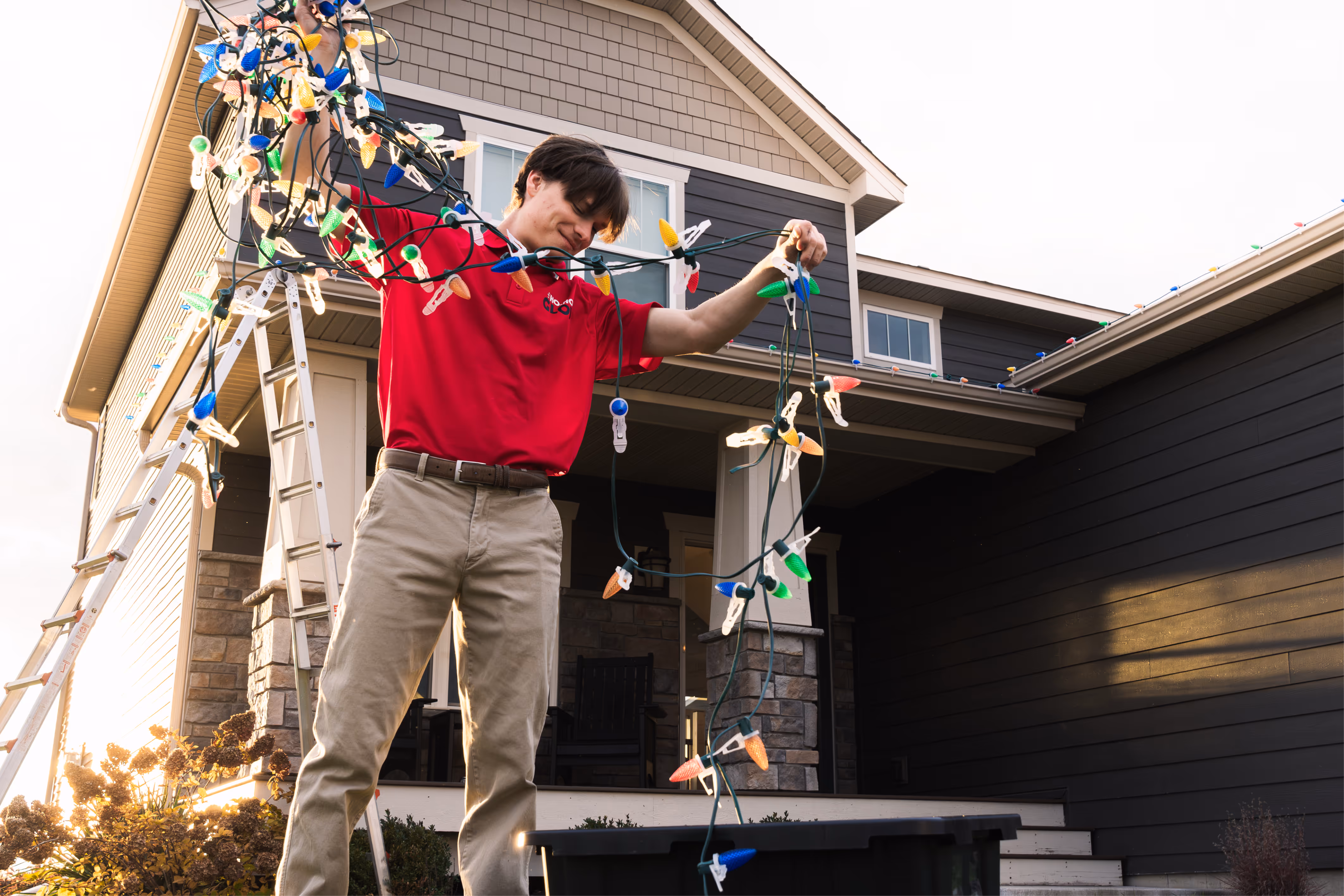 Employee taking down professional Christmas lights