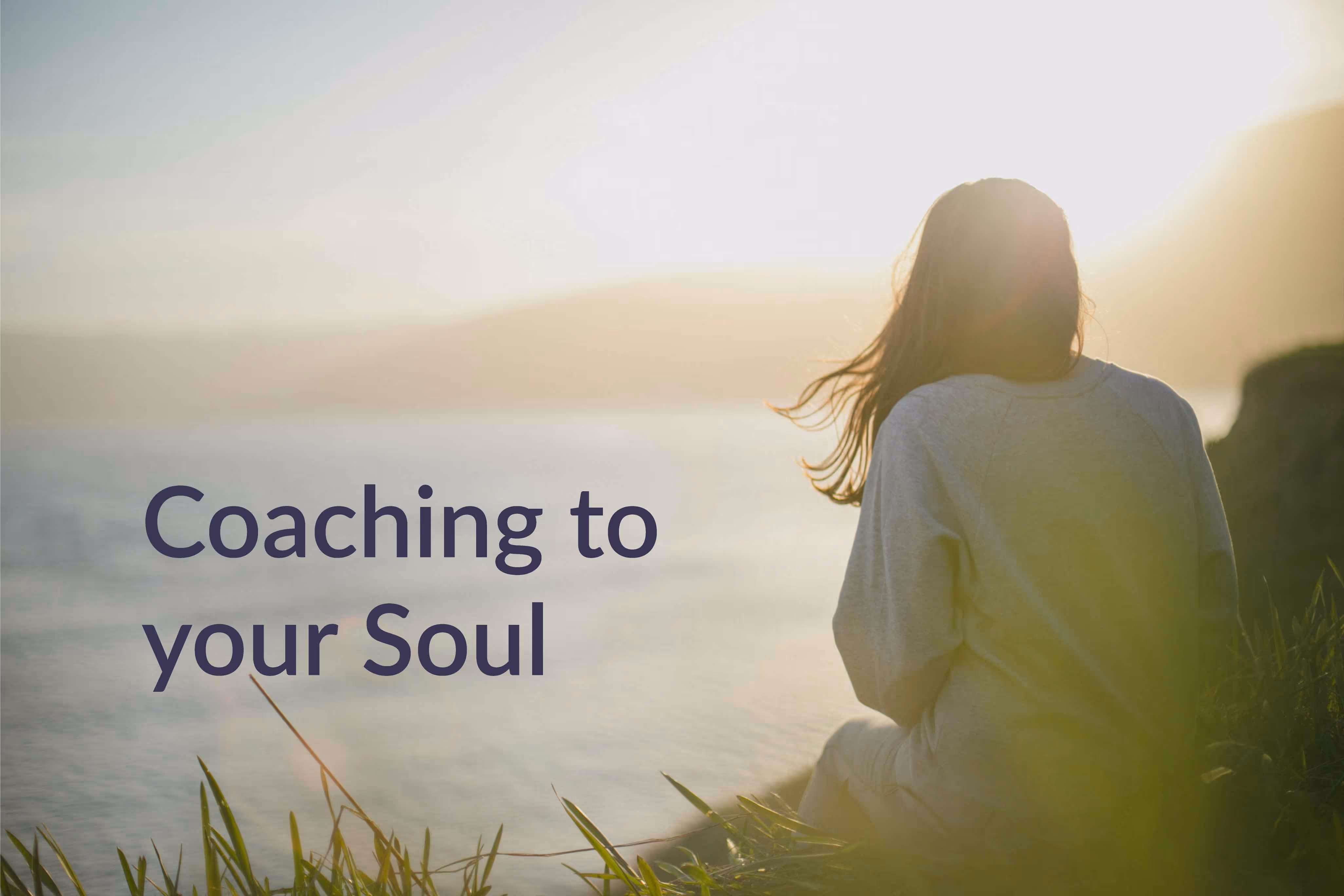 Person with long hair sitting at sunset with text 'Coaching to your Soul.'