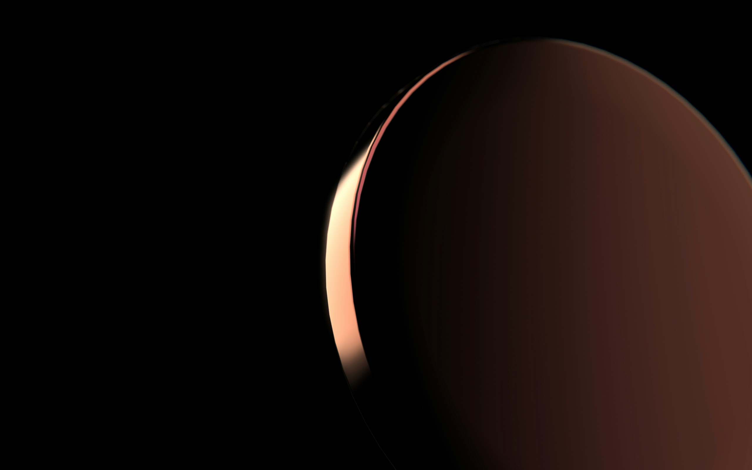 Planet with a dark surface partially illuminated by sunlight against a black space background.