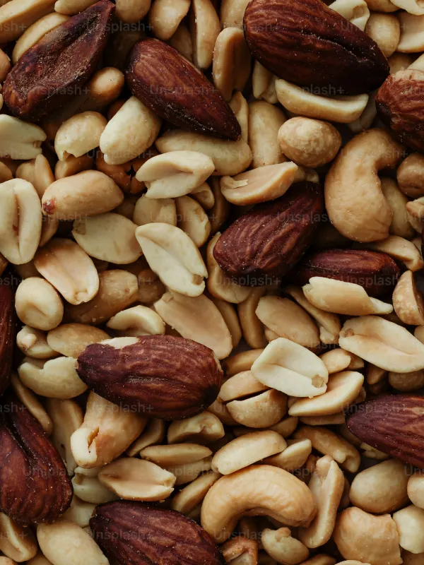 Close-up of mixed nuts including almonds, cashews, and peanuts.