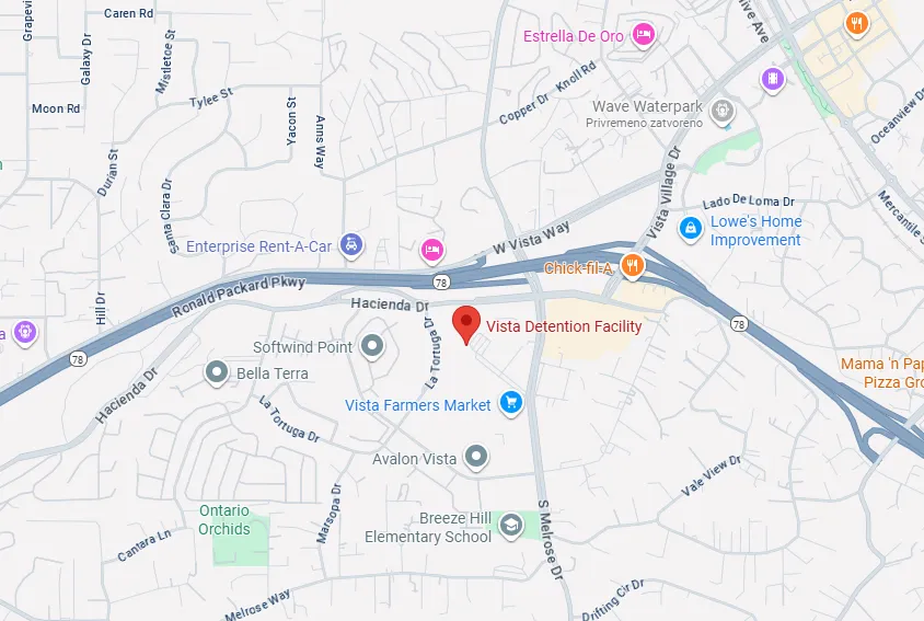 Map showing Vista Detention Facility location near Ronald Packard Parkway and W Vista Way, with nearby landmarks including Vista Farmers Market, Breeze Hill Elementary School, and Lowe's Home Improvement.