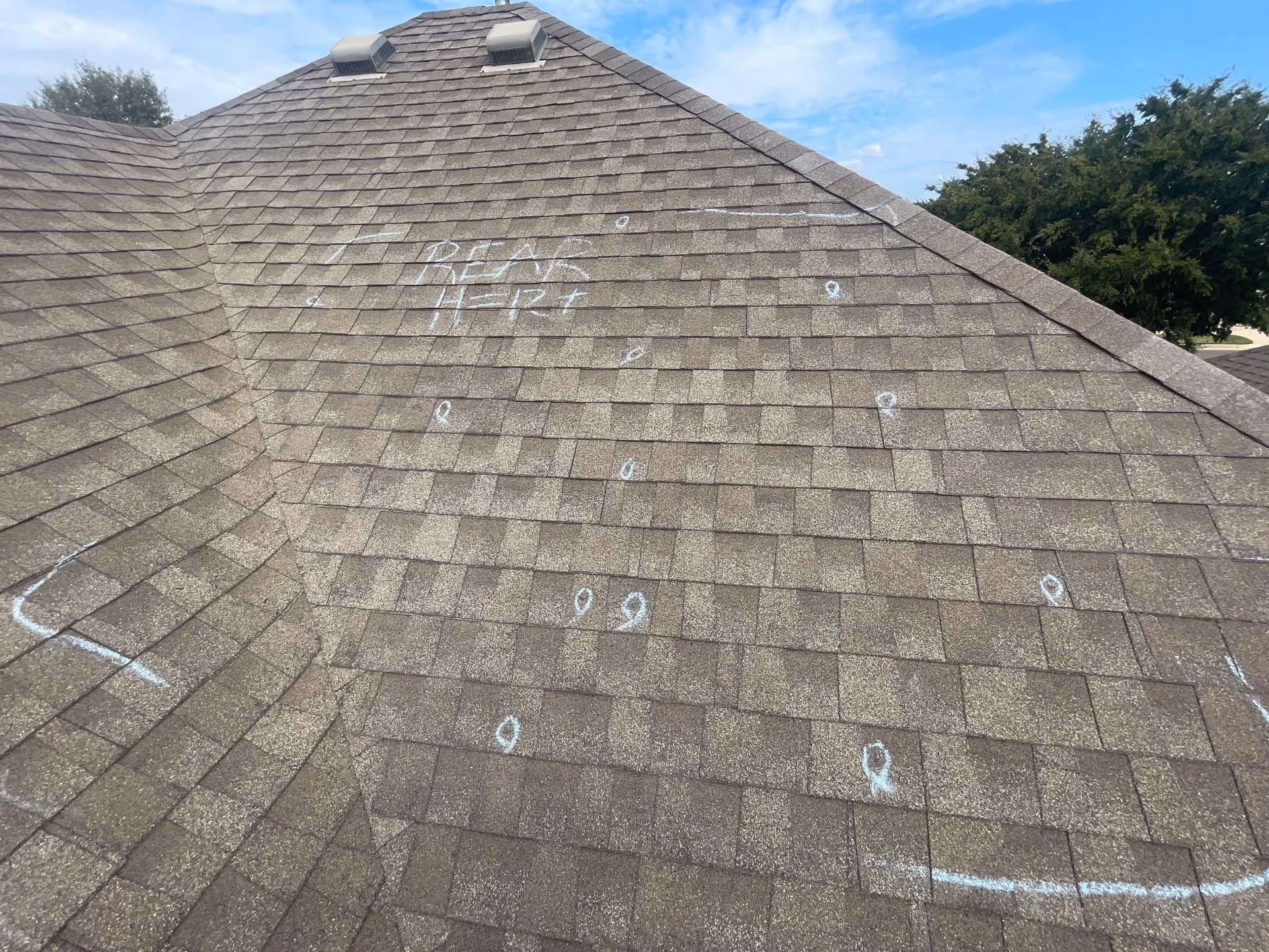 A residential roof in Oklahoma City showing markings from hail damage from a recent storm.