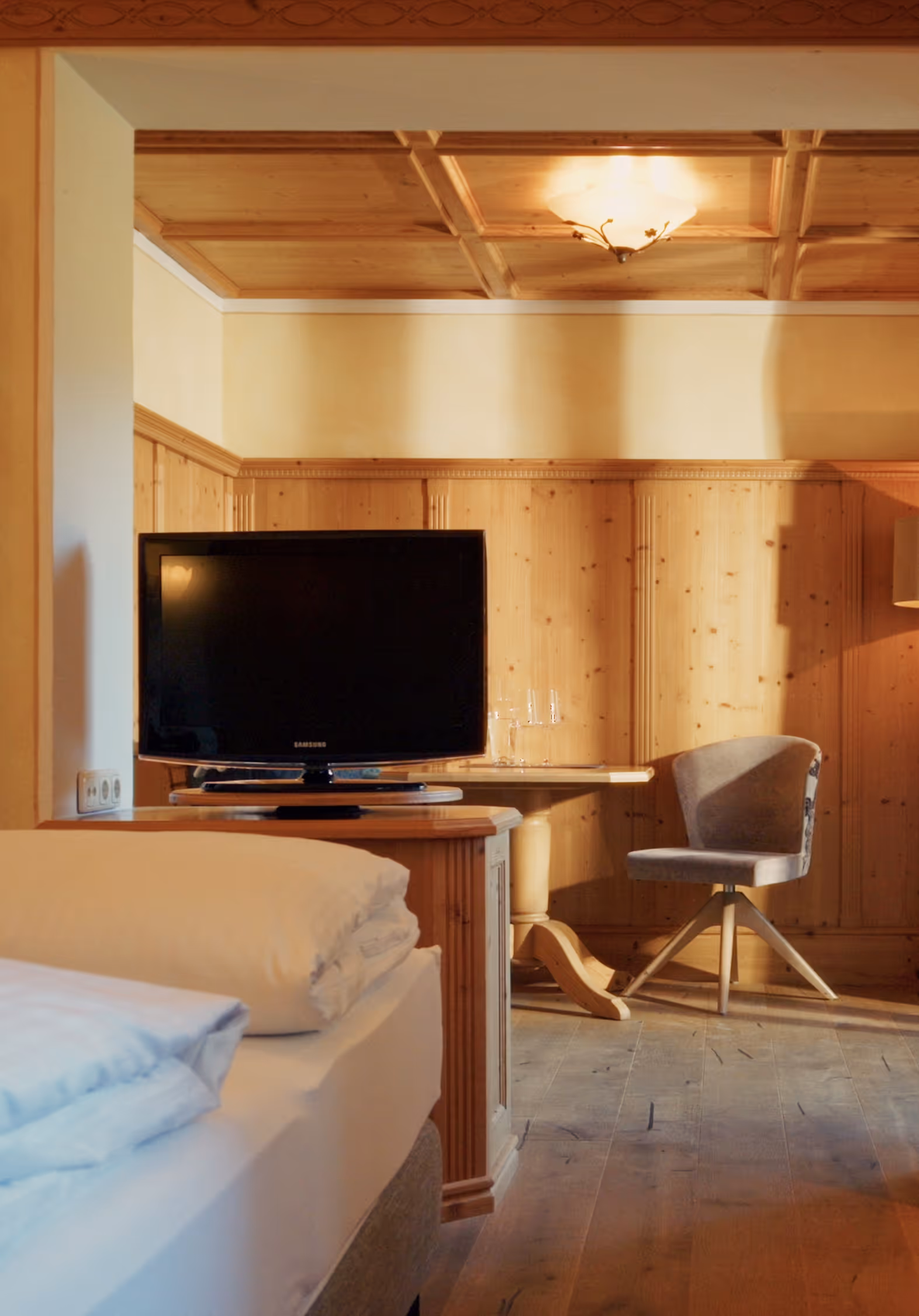 Gemütliches Doppelzimmer Edelweiß im Hotel Hohenfels mit hellen Holzelementen, Fernseher und traditioneller Einrichtung.