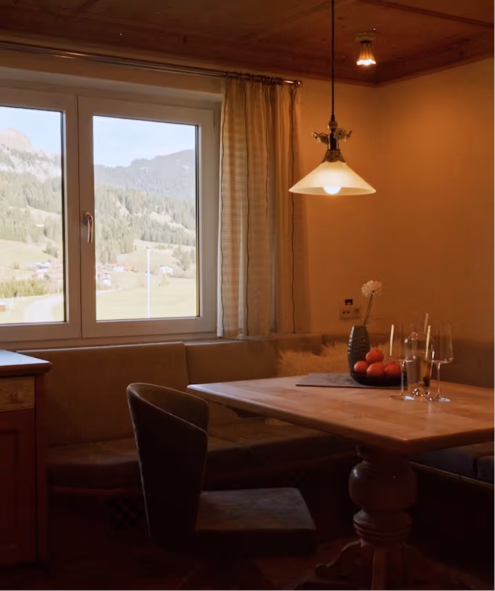 Offene Küche mit gemütlicher Sitzecke und Bergblick – Familiensuite im Hotel Hohenfels Tannheimer Tal.