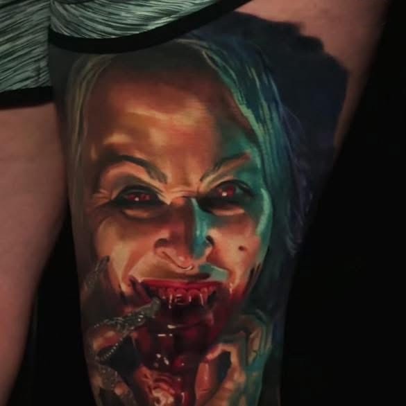Color realism portrait horror tattoo of a sinister female face.