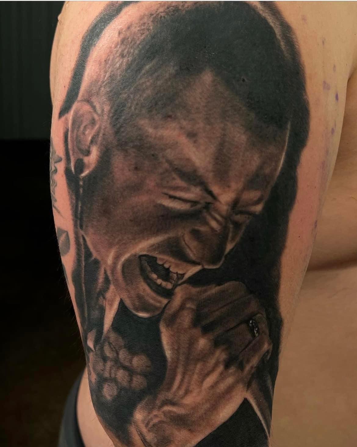 Black and gray portrait tattoo of Chester Bennington.