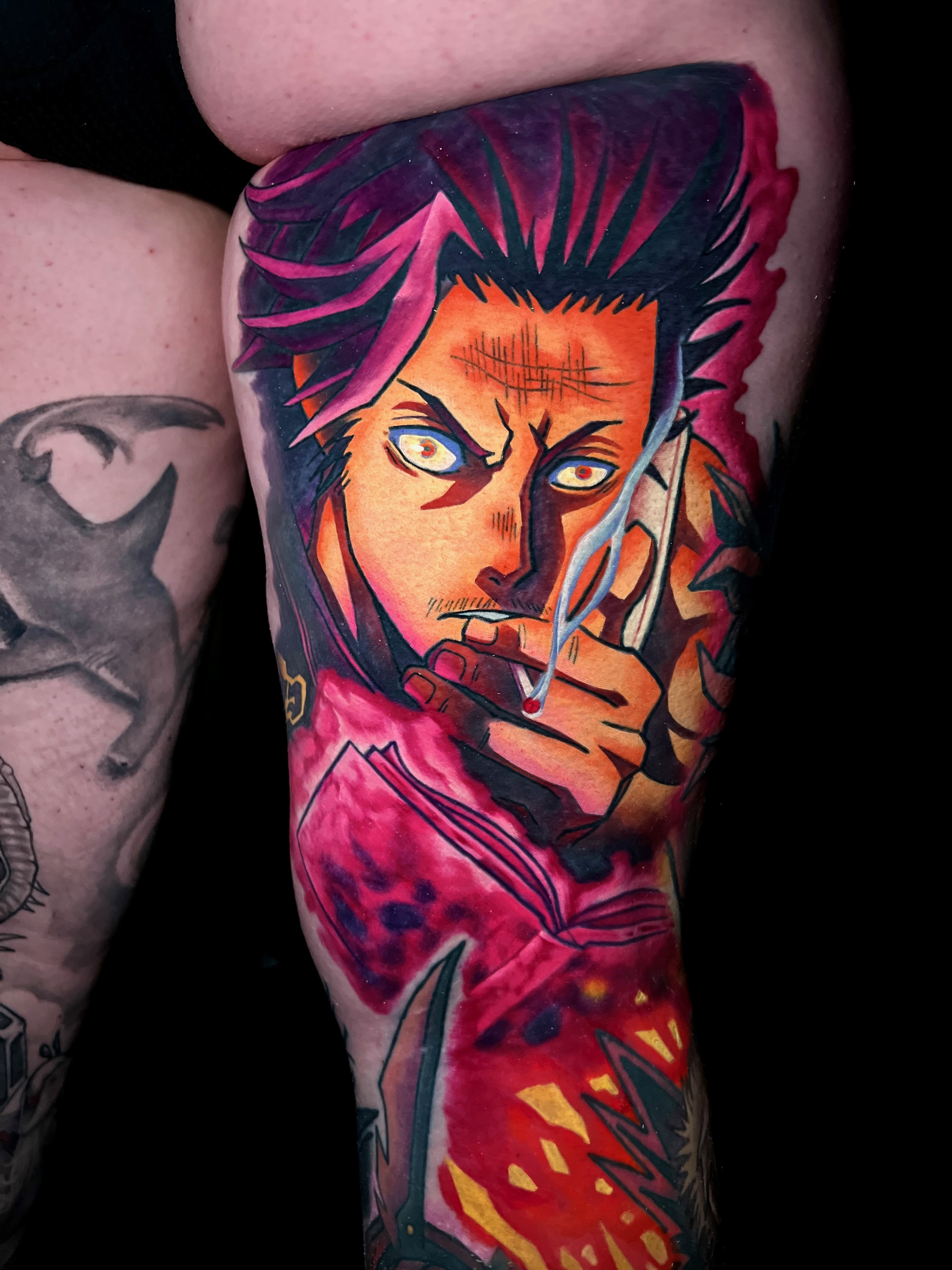 Colorful tattoo anime character holding a cigarette and an open book with fiery red and yellow background.