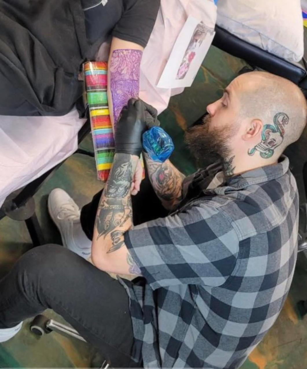 Cam Corral a tattoo artist at Plus Ultra Tattoo Studio.