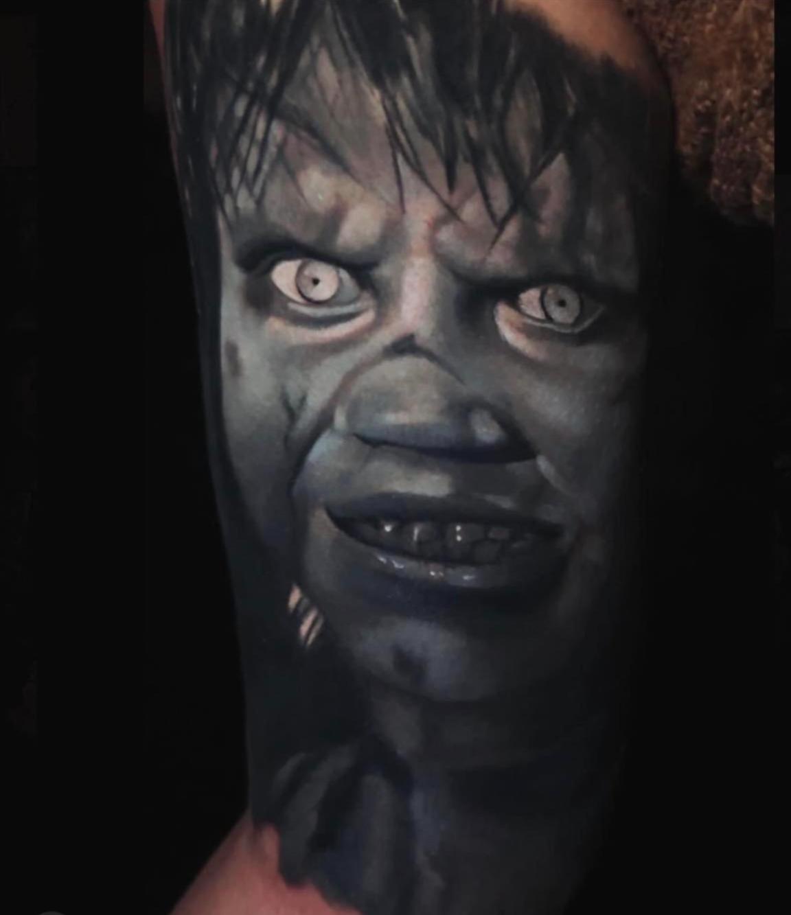 Color realism portrait tattoo of Exorcism movie young girl's face.