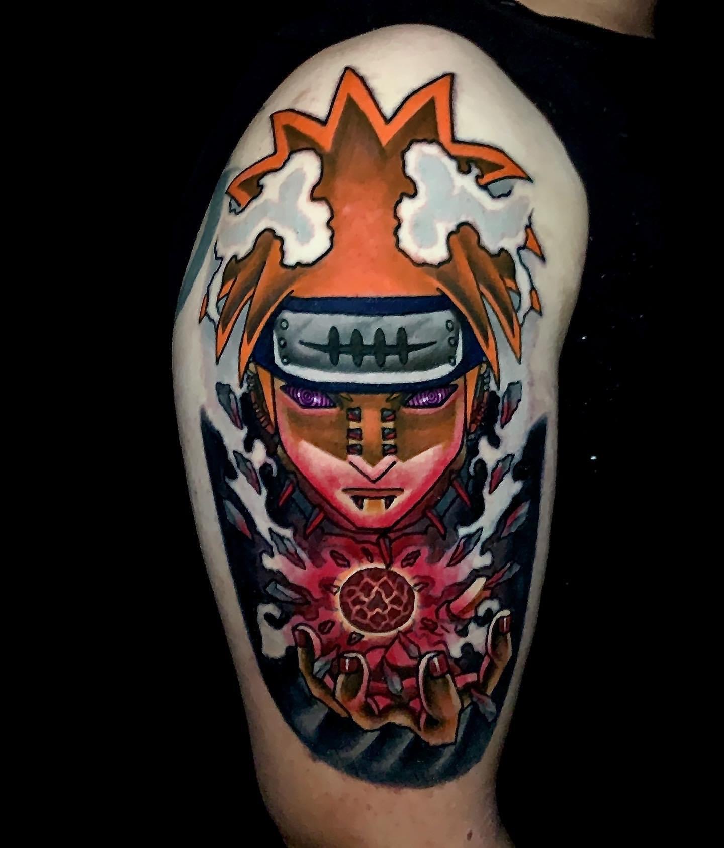 Tattoo of an Naruto anime character with spiked orange hair.