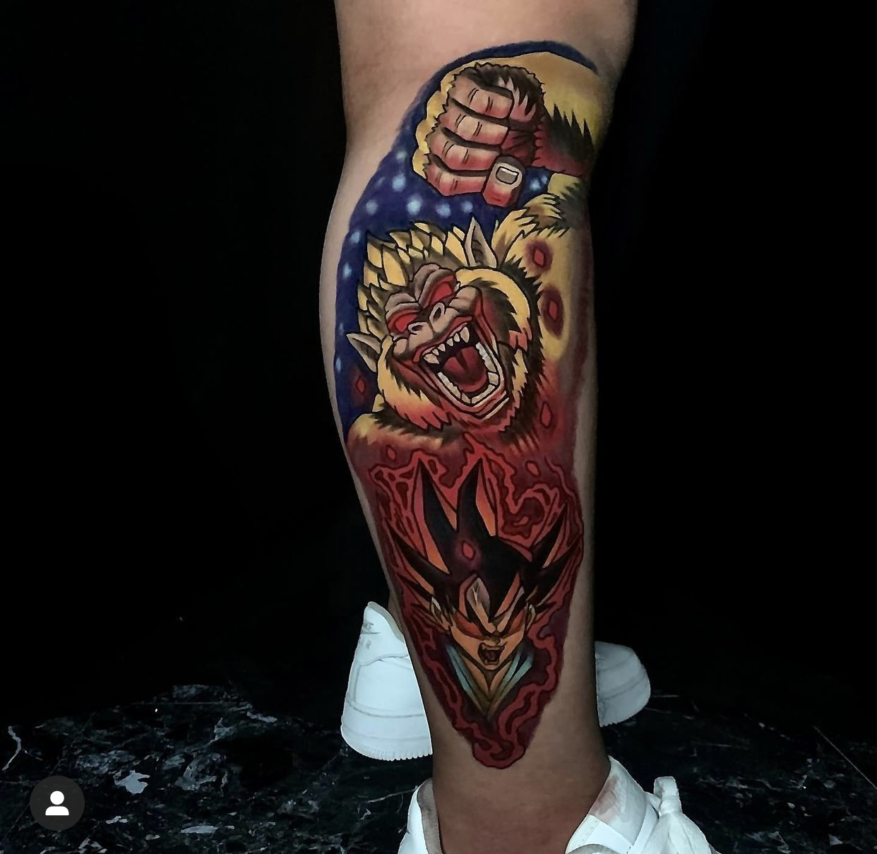 Colorful tattoo on a calf depicting a roaring ape and an intense anime-style character.