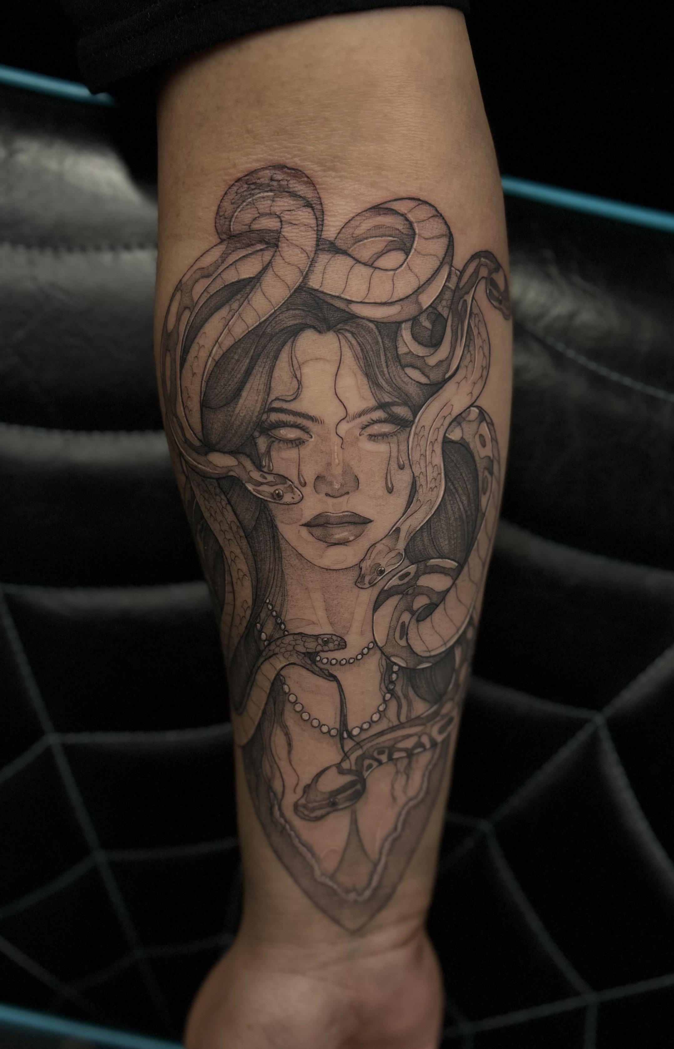 Fine line forearm tattoo of a Medusa