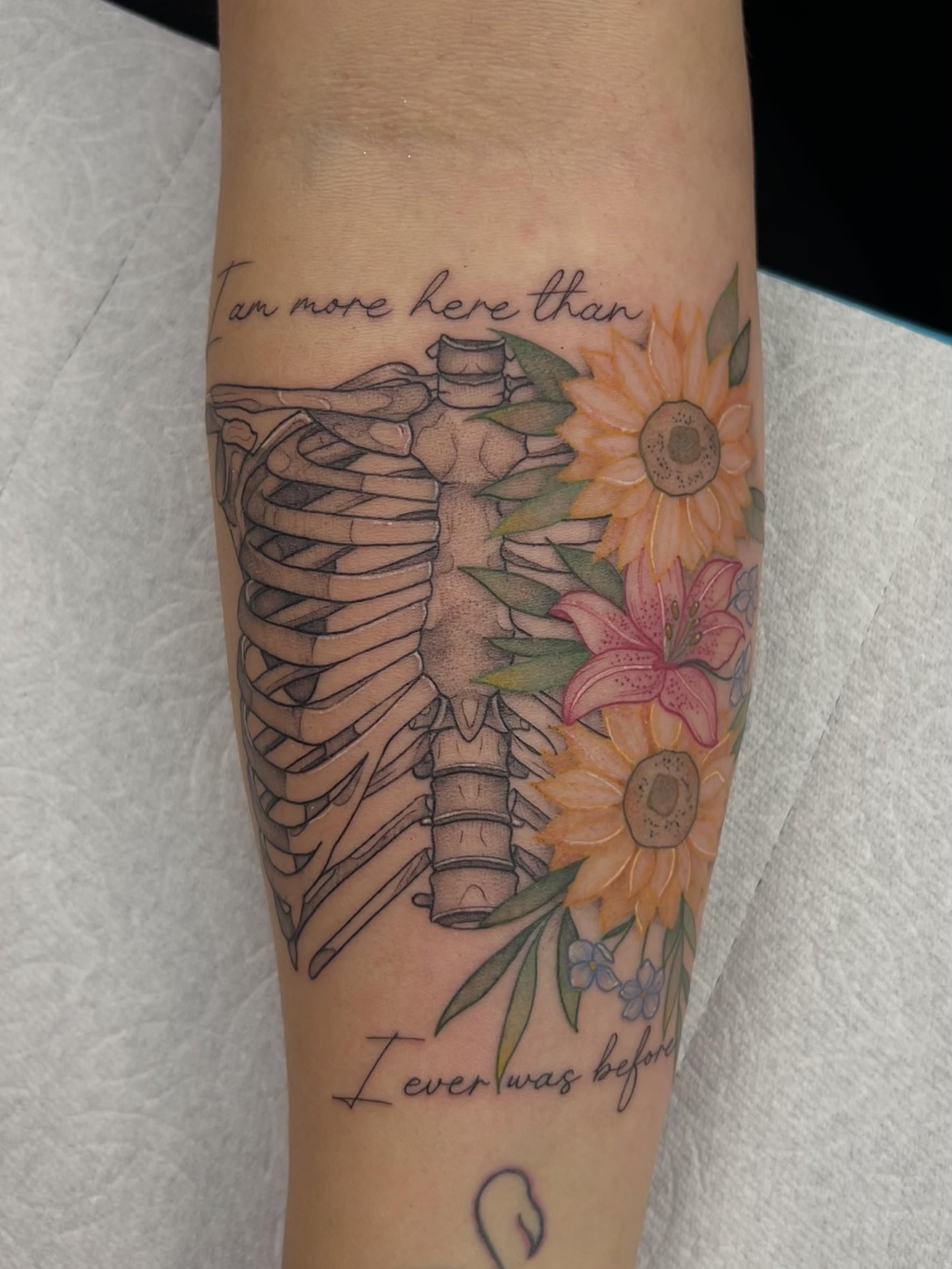 Fine line tattoo of a ribcage skeleton on a forearm