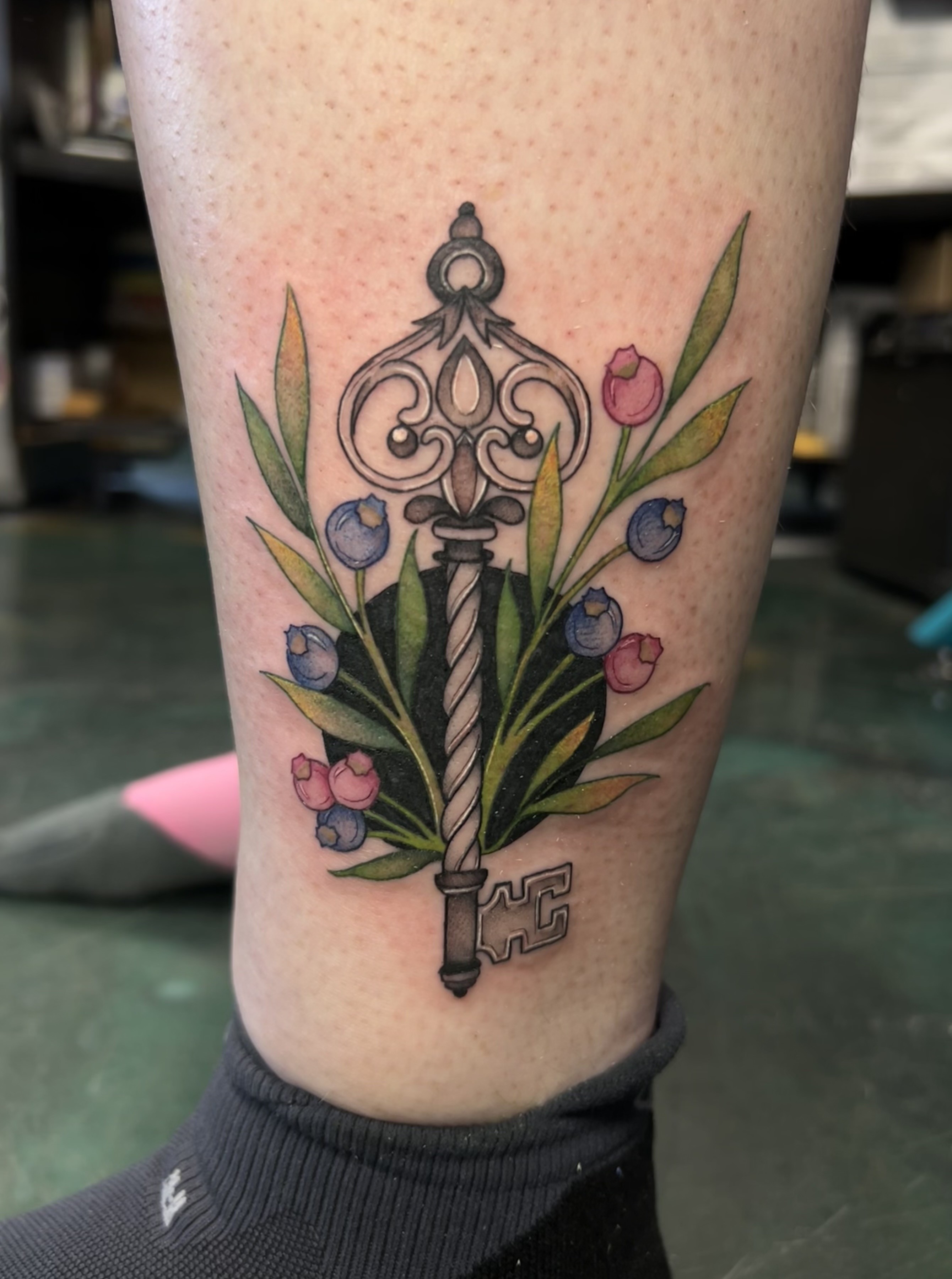 Tattoo of an ornate vintage key fine line