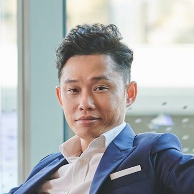 image of a volunteer mentoring teenagers in a tech workshop