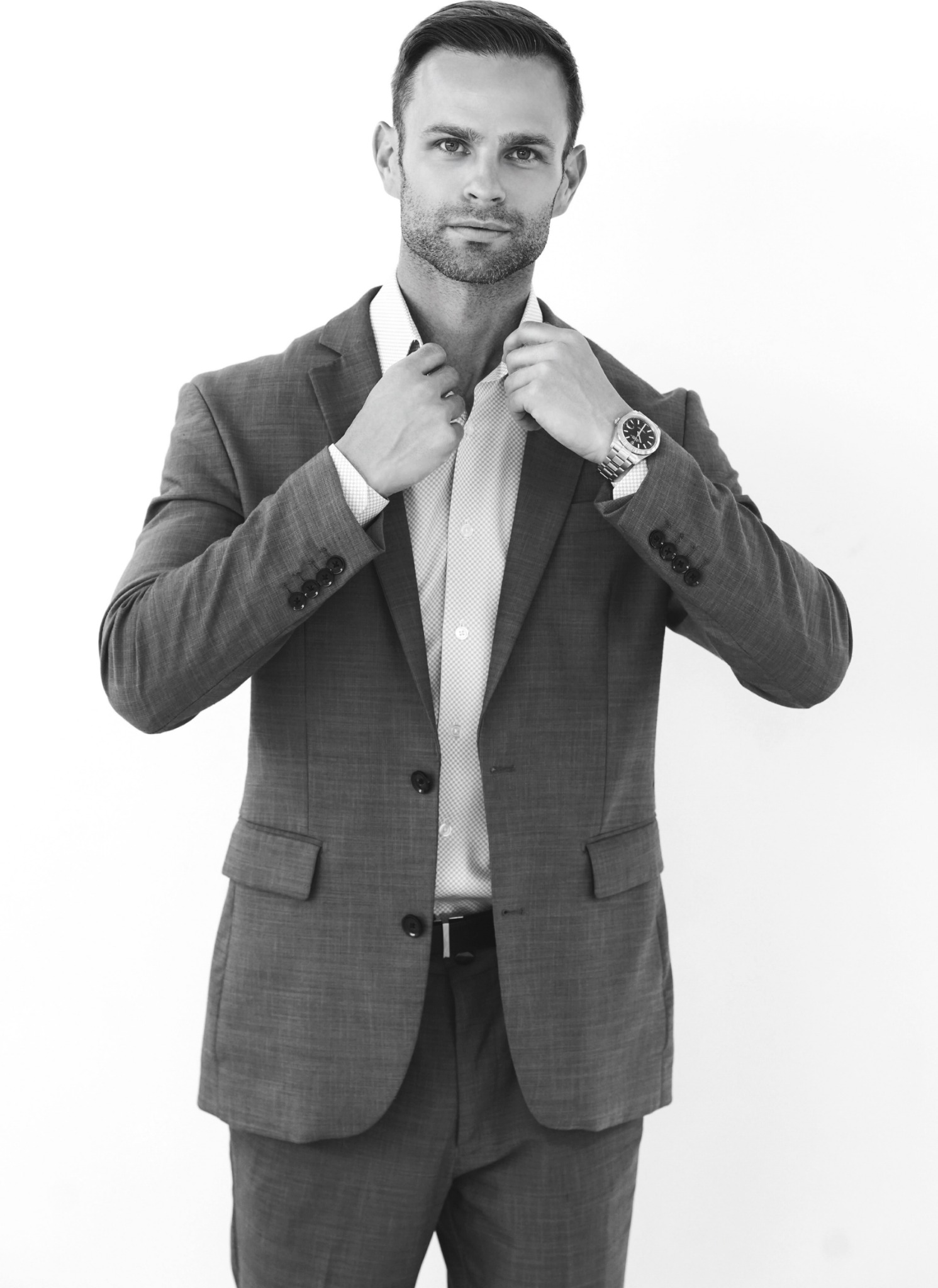 Black-and-white professional portrait of a man in a suit