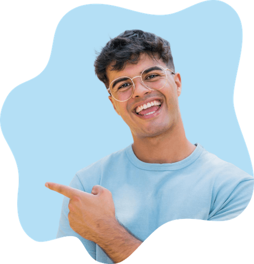 Smiling man with glasses wearing a light blue shirt pointing to the left on a blue abstract background.