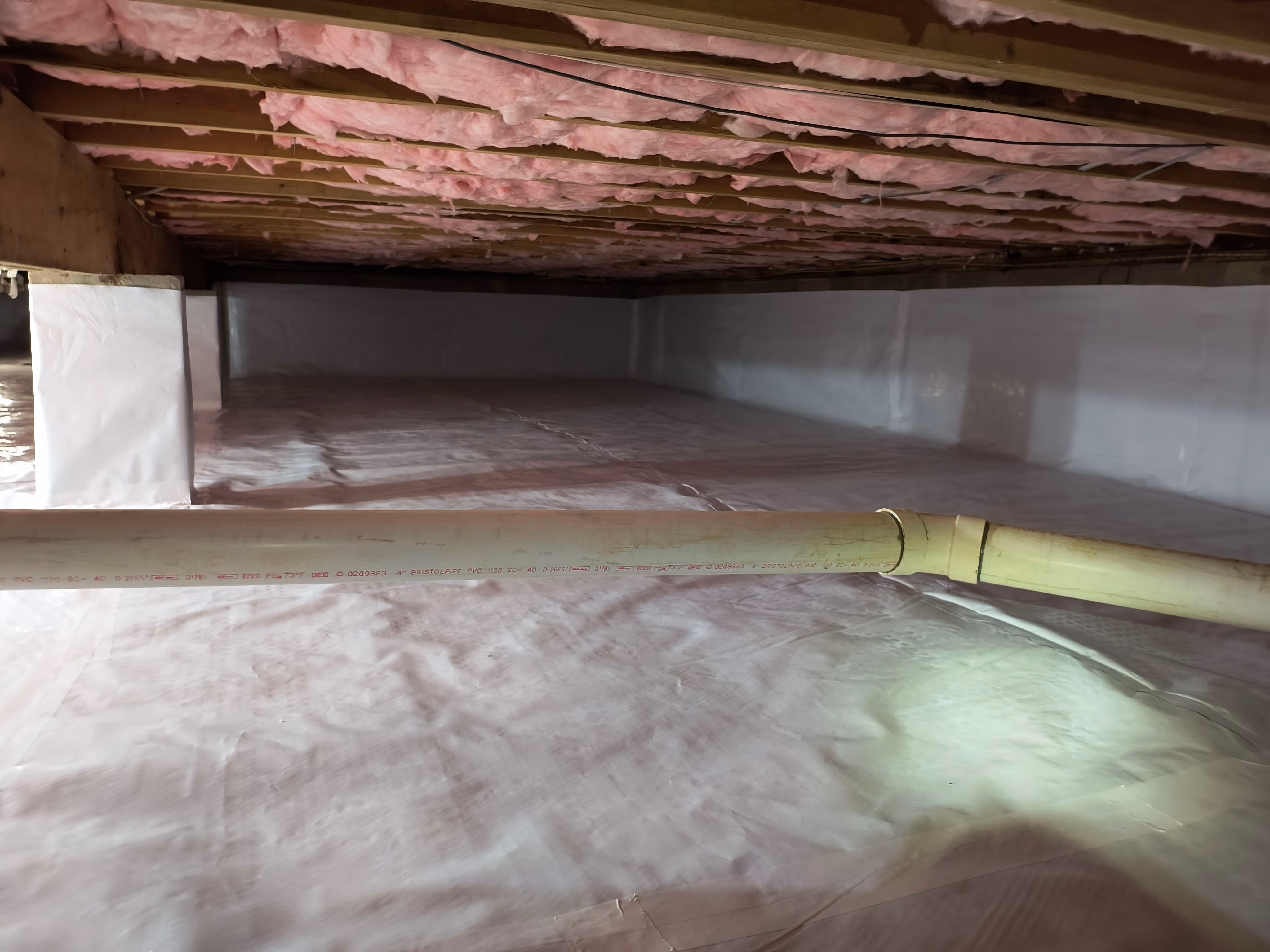 A vapor barrier installed on the floor, walls and pillars with Kraft Faced