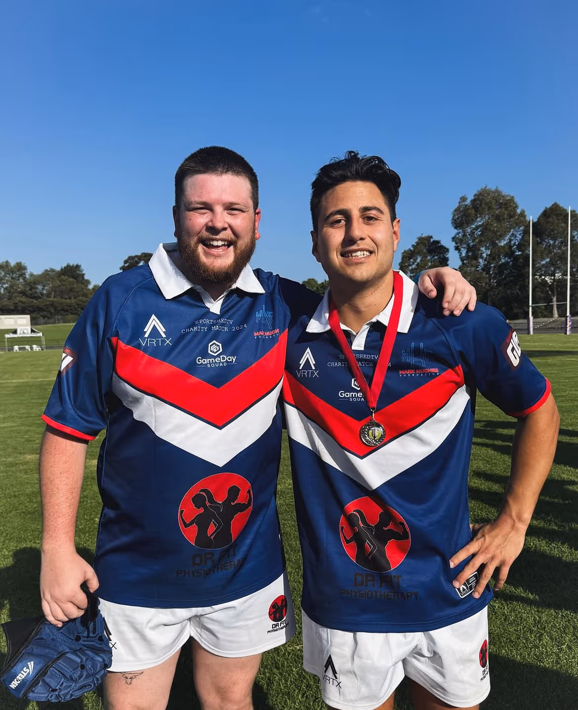 Nathan posing with his teammate at a rugby game