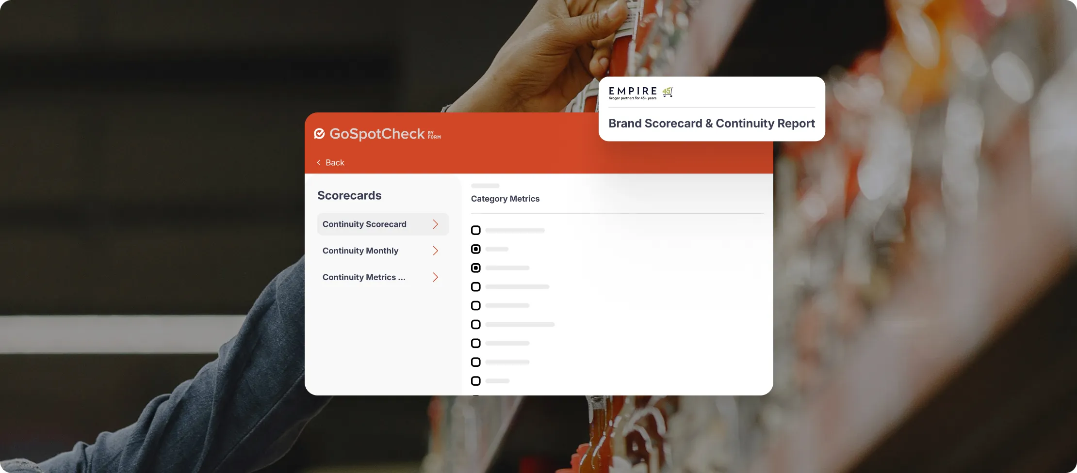 Dashboard screen of GoSpotCheck app showing scorecard options and category metrics overlay on background of person stocking store shelves.