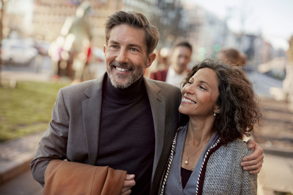 a man and a women smiling together outside