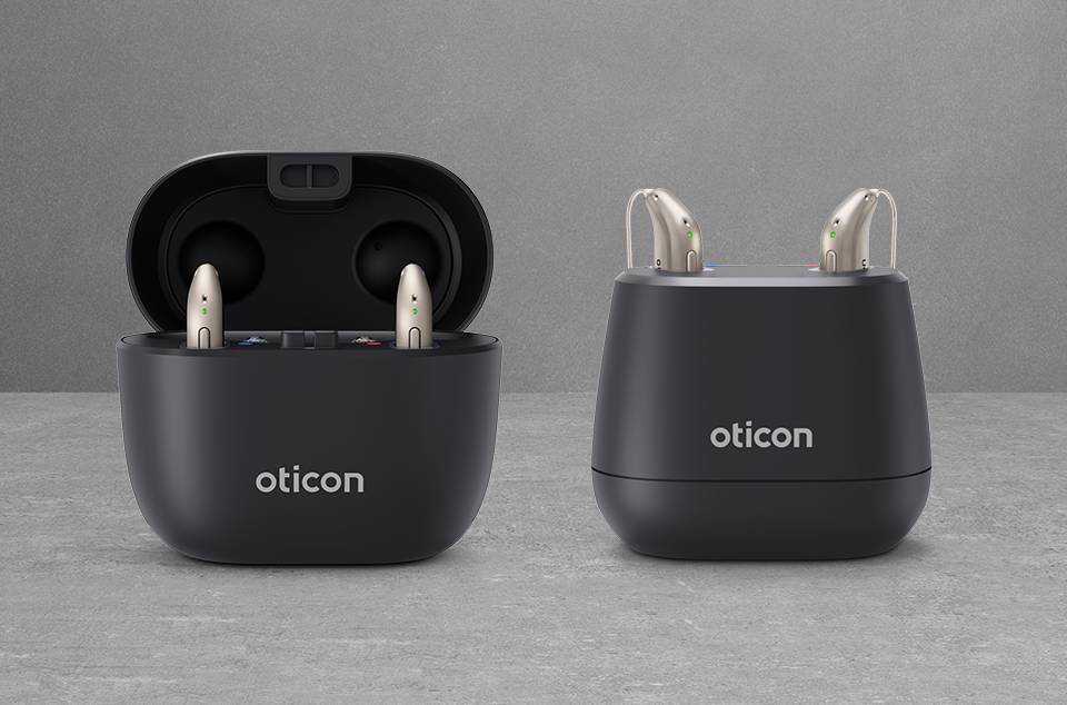 Oticon Intent hearing aids in charging stations.