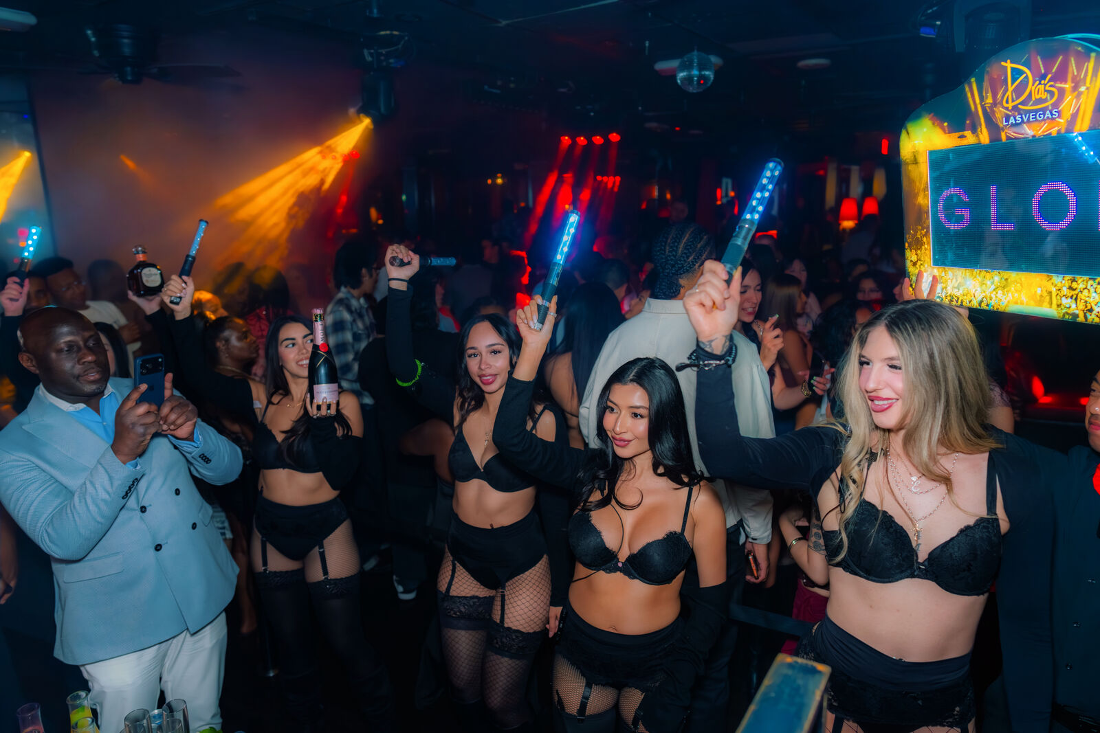 Bottle servers bring glowing wands through the crowd at Drai's After Hours