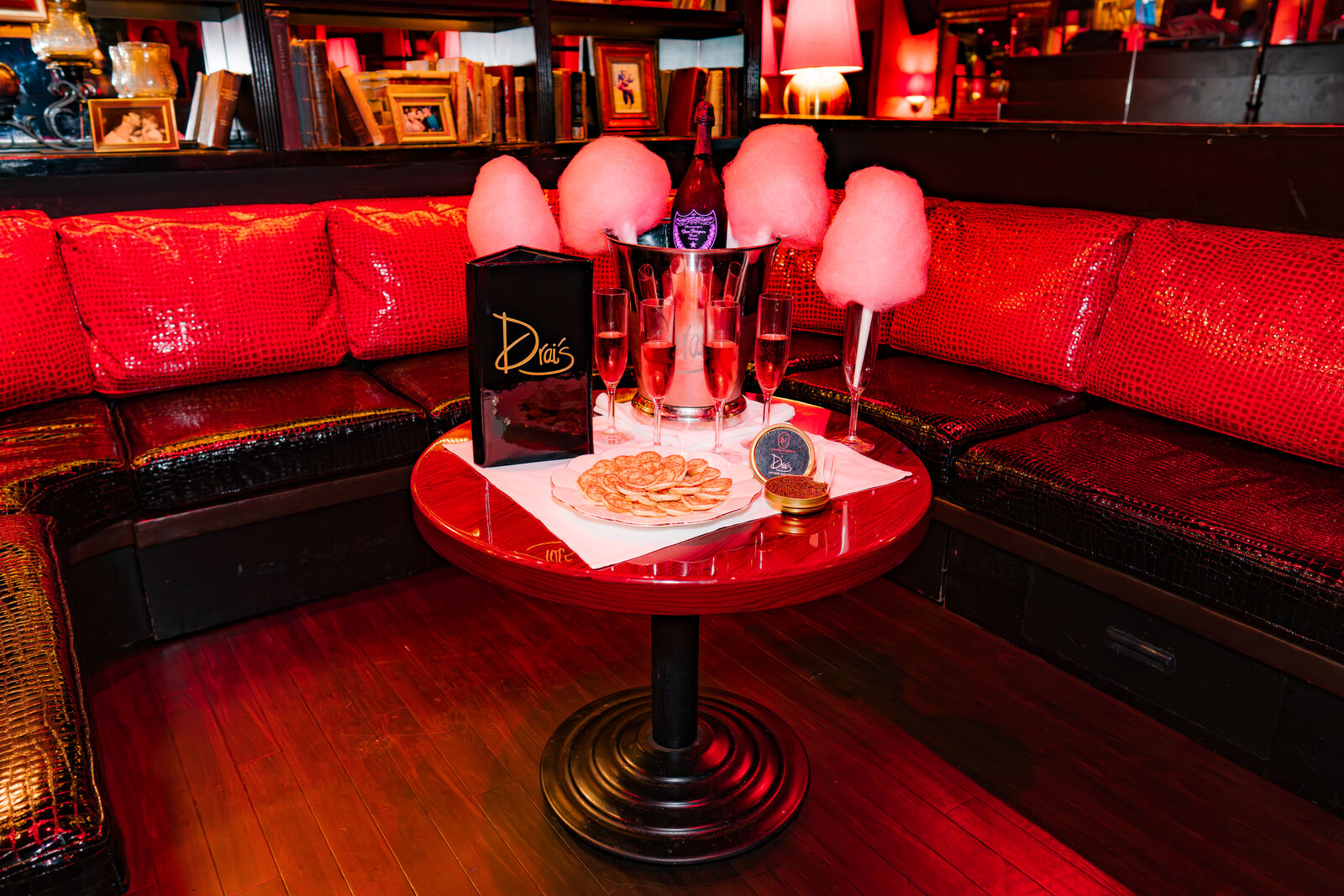 A reserved table set with champagne and cotton candy at Drai's After Hours