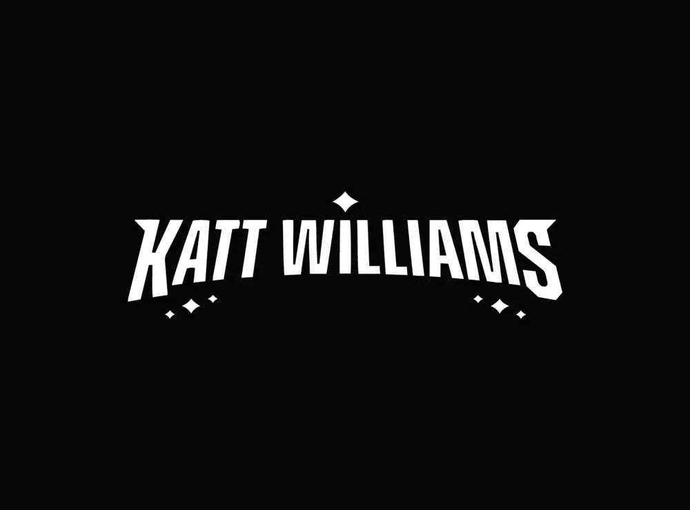Stylized white text reading 'Katt Williams' with small diamond shapes above and below on a black background.