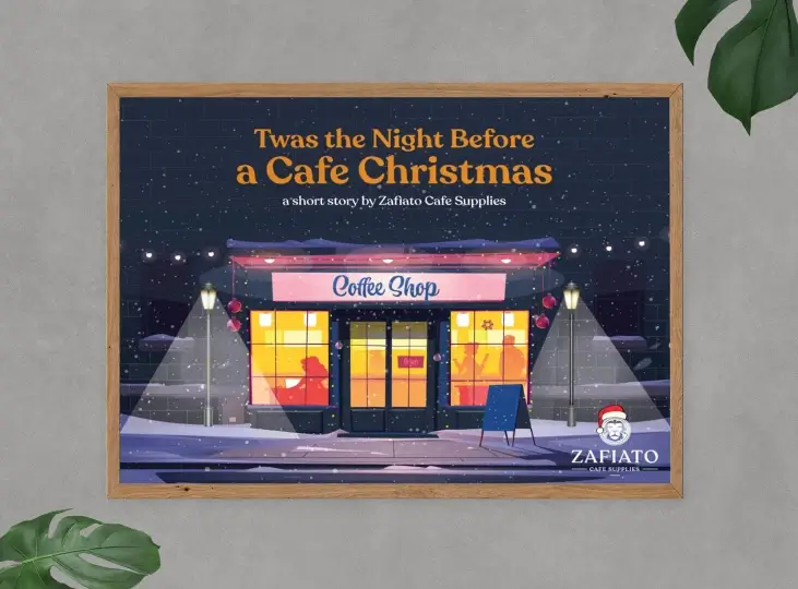 Framed illustration of a cozy coffee shop at night with snow falling, titled 'Twas the Night Before a Cafe Christmas' by Zafiato Cafe Supplies.