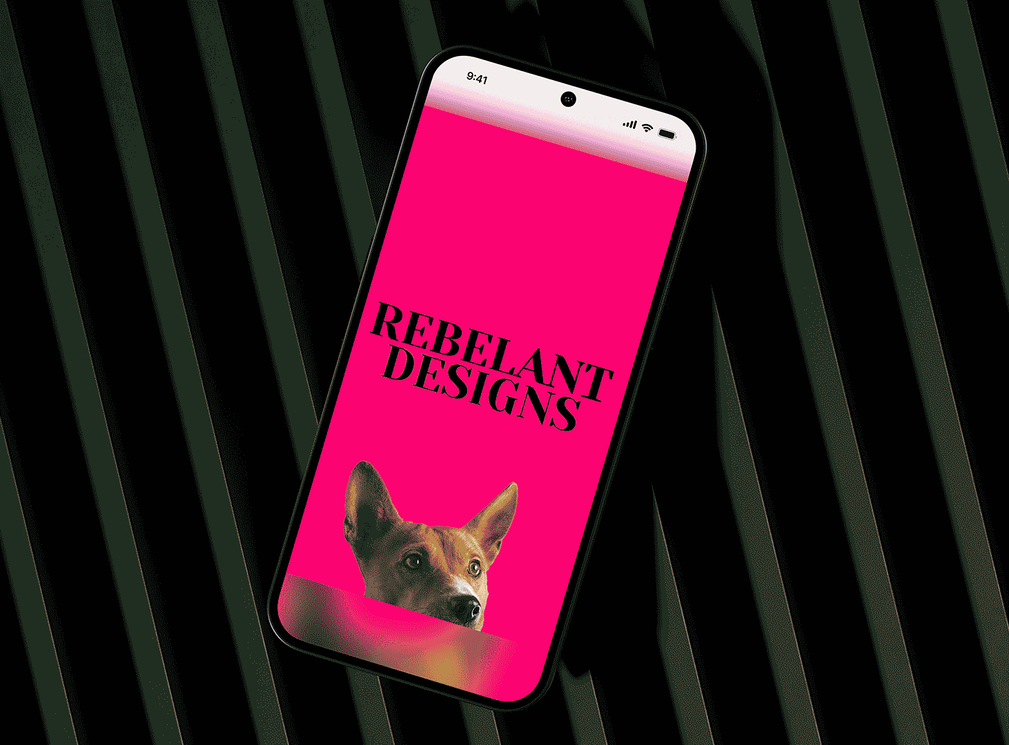 Smartphone displaying a pink screen with the text 'REBELANT DESIGNS' and a dog's head peeking up.