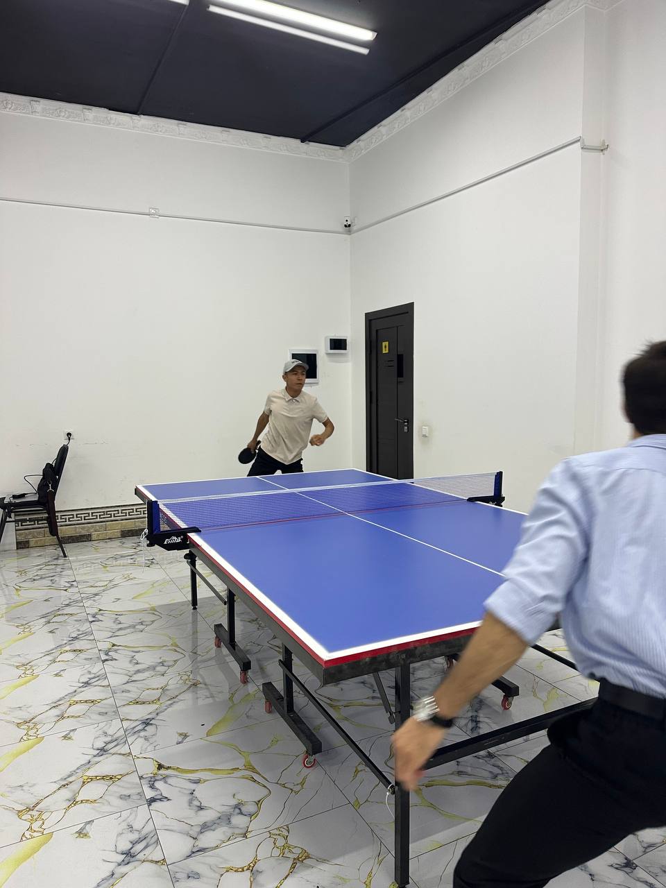 teachers playing tennis on table in school itselv