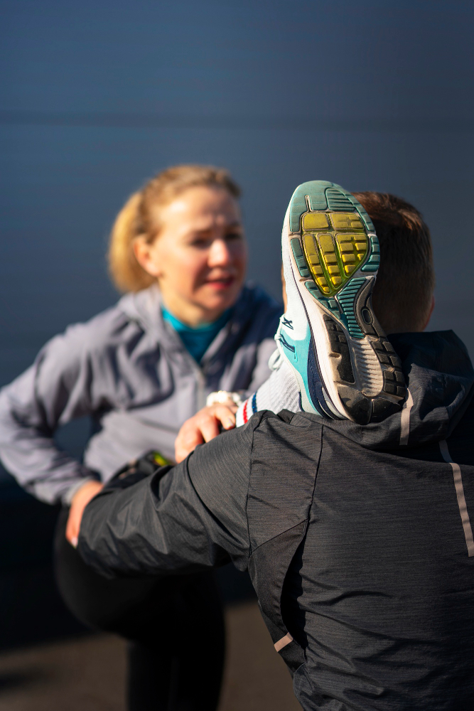 Physical therapist demonstrating shoulder mobility assessment with athlete at Kinetic Milwaukee location