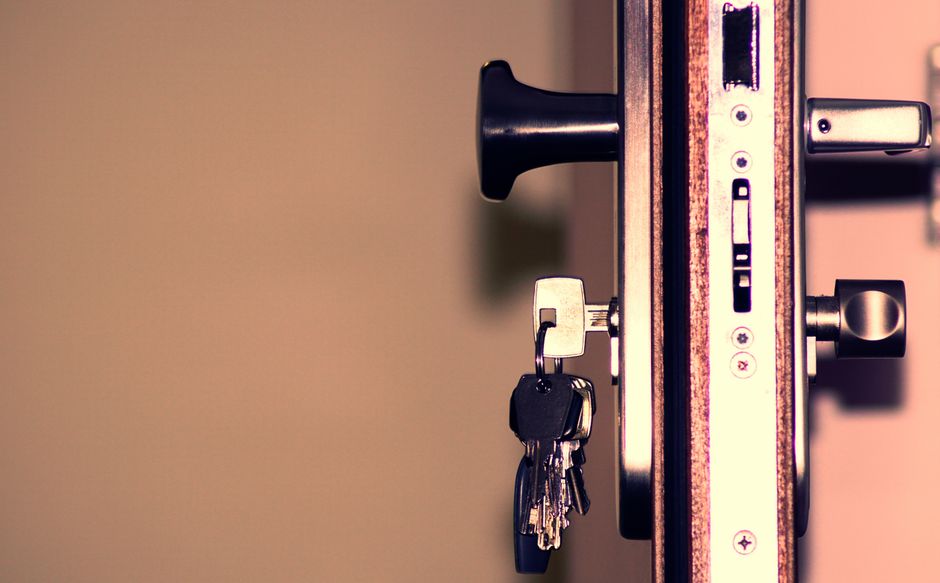 Trousseau de clés inséré dans la serrure d'une porte d'entrée sécurisée