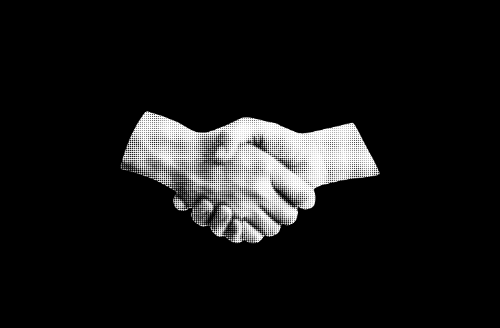 Person working on two computer screens.