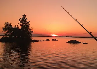 Island at sunset on Eagle Lake with a fishing rod in the foreground