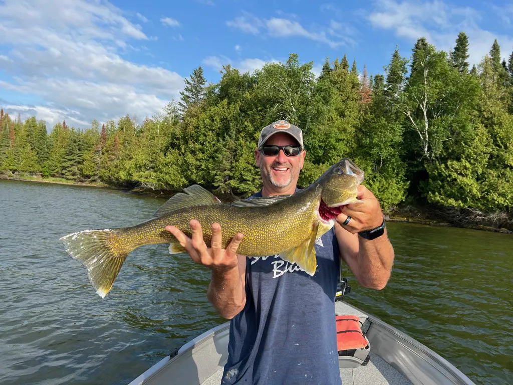Angler holding a walleye caught on Eagle Lake