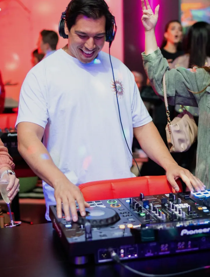 Man DJ smiling while mixing music