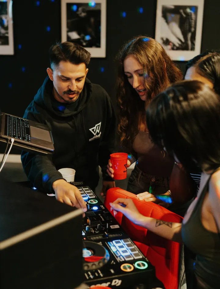 Instructor teaching group on DJ controller