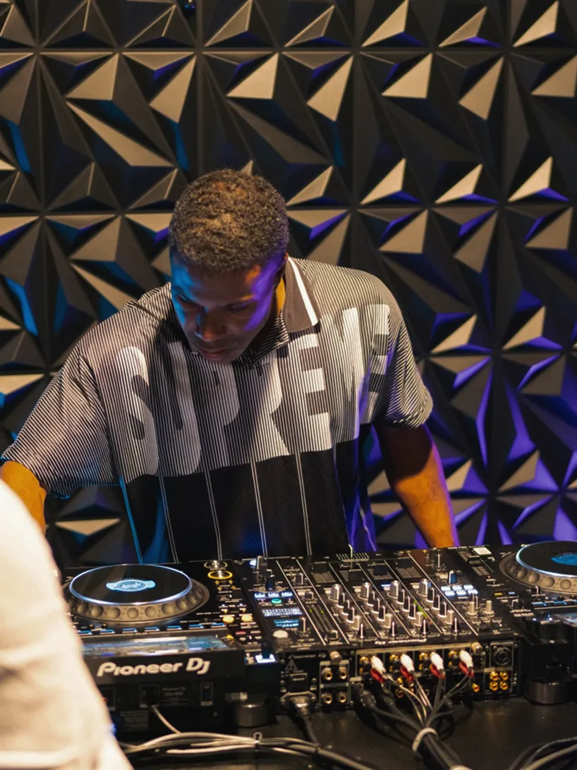 DJ performing on stage in front of a large crowd